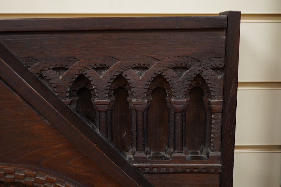 A carved oak firescreen in form of a Norman Romanesque church door and frontage Height 69cm. Width 62cm. Condition - fair
